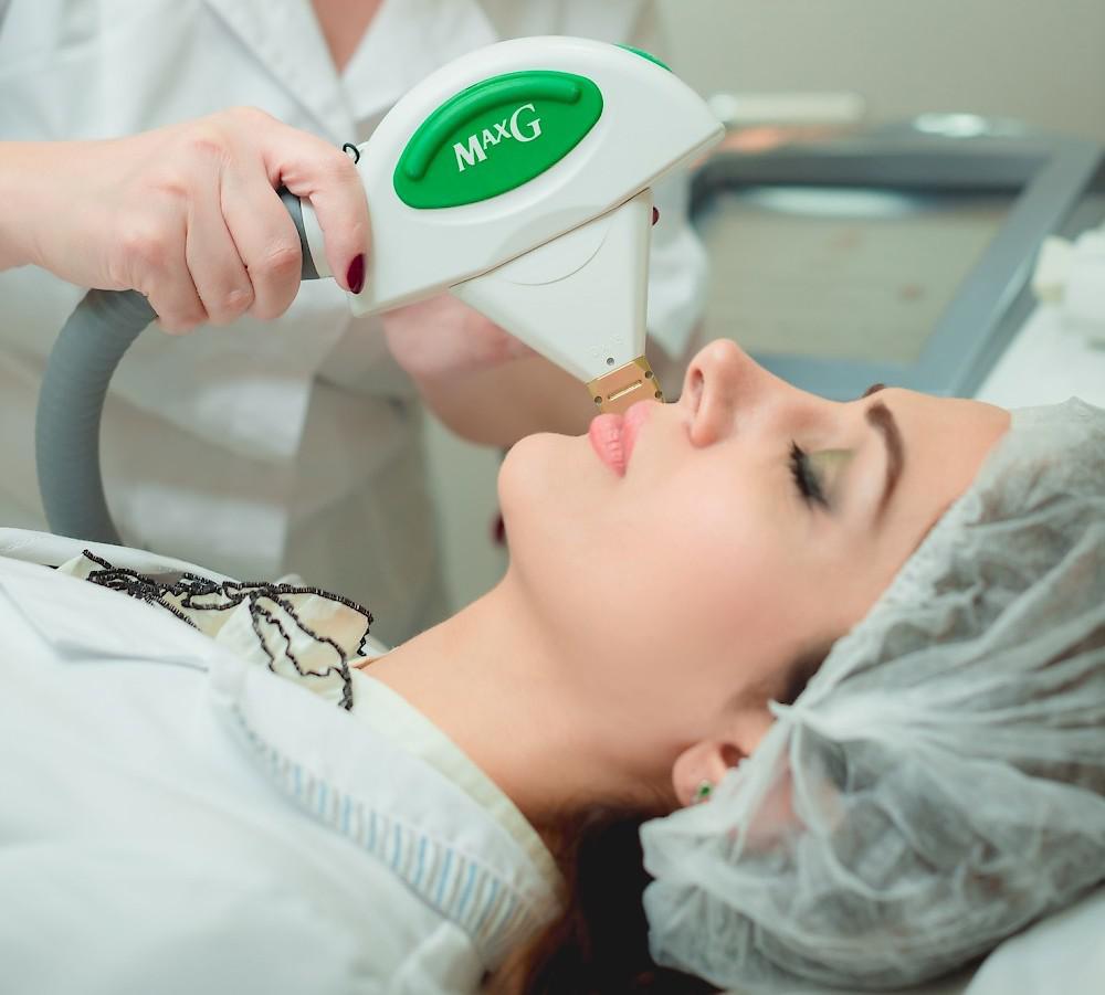 1934406 Photo of a female patient receiving IPL skin rejuvenation on her facial skin.